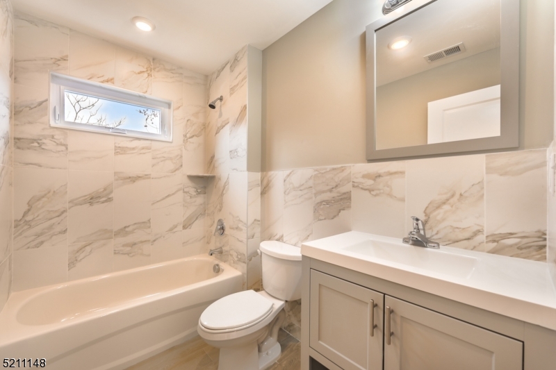 255 Chadwick Avenue, Unit 2 Newark, NJ 07108 - Photo 14 of 23 a bathroom with a sink toilet and shower