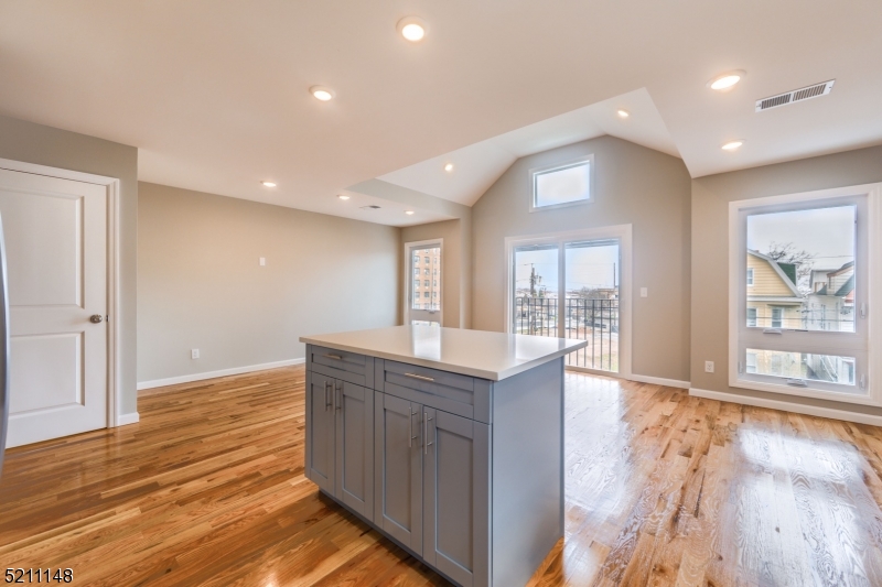 255 Chadwick Avenue, Unit 2 Newark, NJ 07108 - Photo 4 of 23 a view of kitchen with wooden floor and outdoor space
