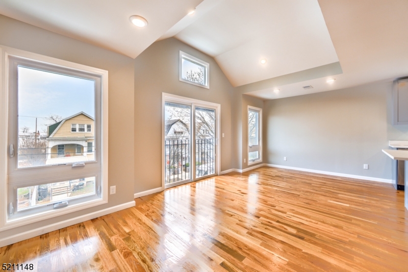 255 Chadwick Avenue, Unit 2 Newark, NJ 07108 - Photo 8 of 23 a view of an empty room with wooden floor and a window