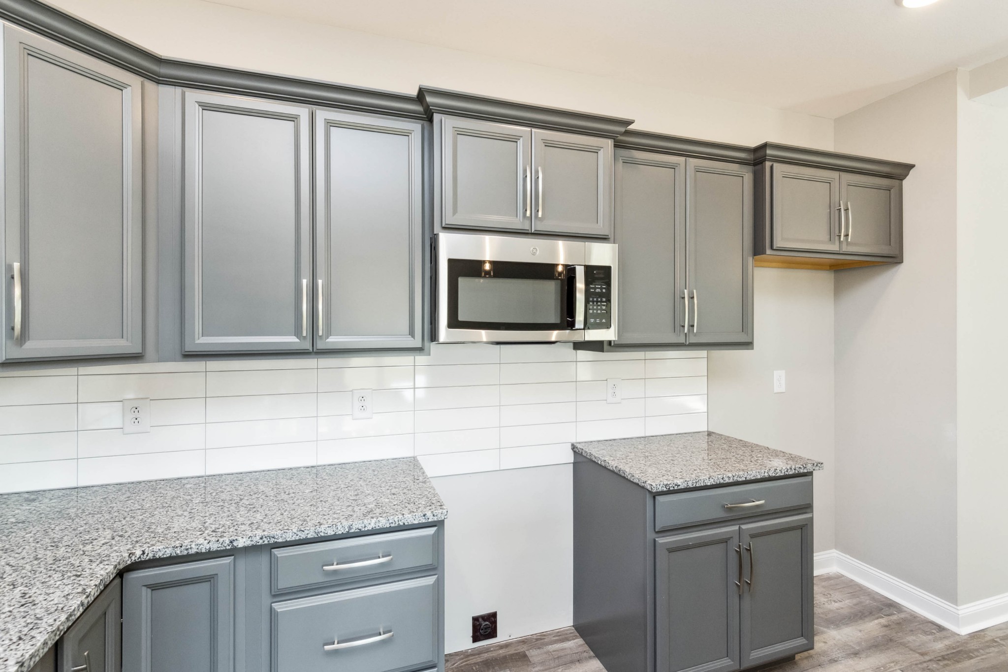584 Lafayette Road Clarksville, TN 37042 - Photo 12 of 36 a kitchen with granite countertop white cabinets and stainless steel appliances