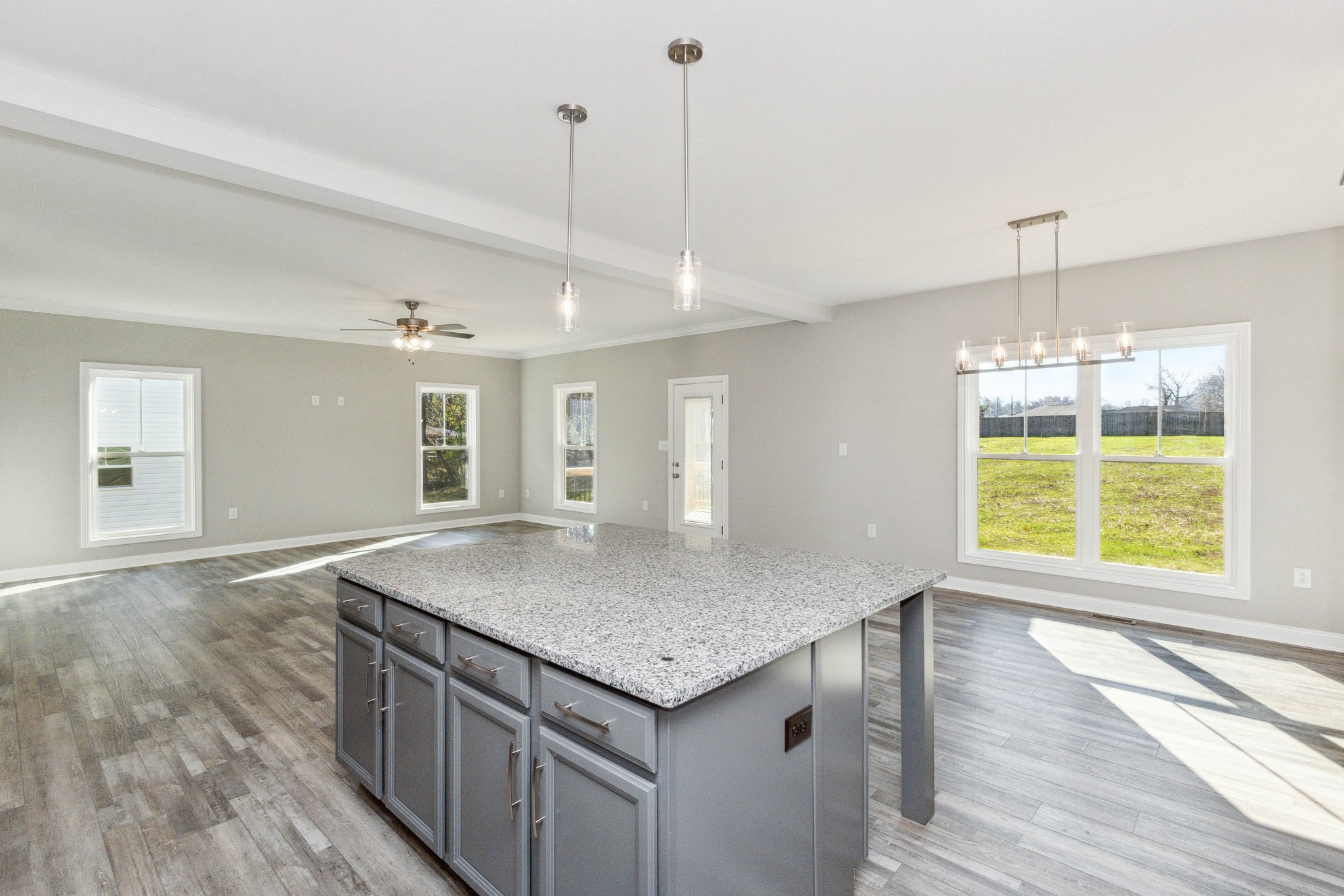 584 Lafayette Road Clarksville, TN 37042 - Photo 13 of 36 a kitchen with a stove center island wooden floor and a window