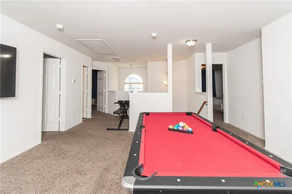 a room with pool table and a table