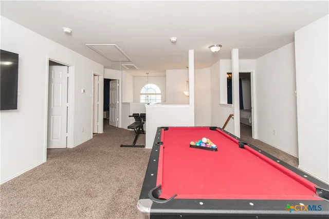 a room with pool table and a table