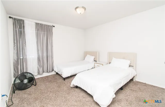 a bedroom with a bed and a chair