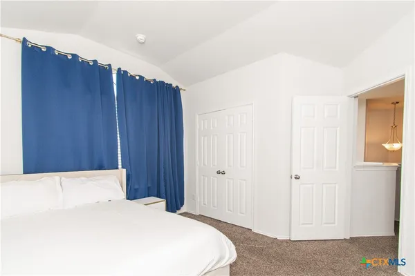 a bedroom with a bed and a dresser