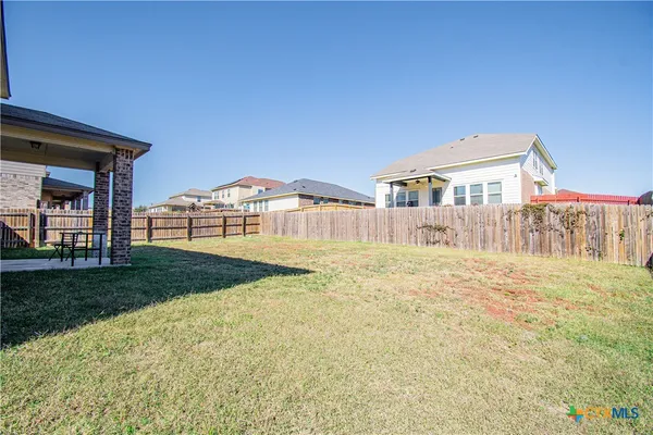 a view of a house with backyard and deck