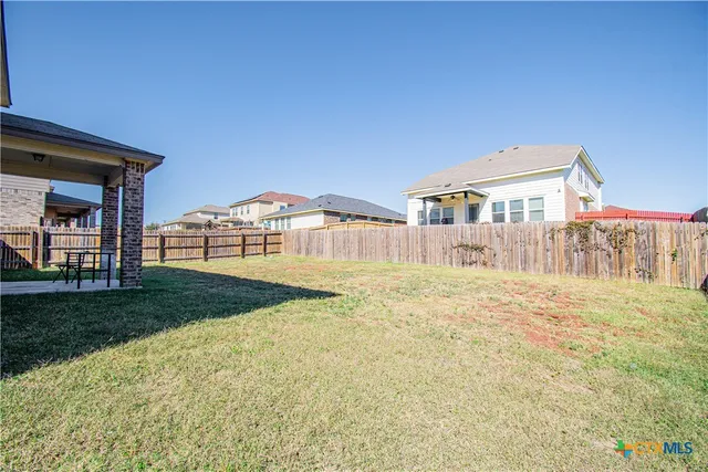 a view of a house with backyard and deck