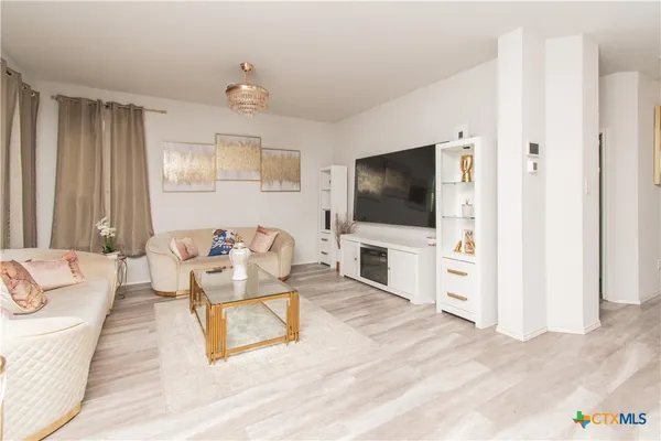 a living room with furniture and a flat screen tv