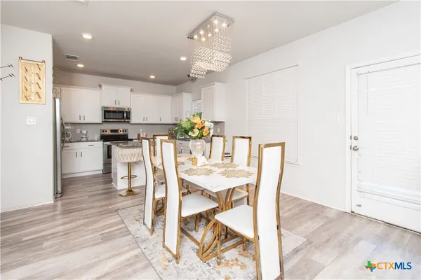 a view of a dining room with furniture and wooden floor