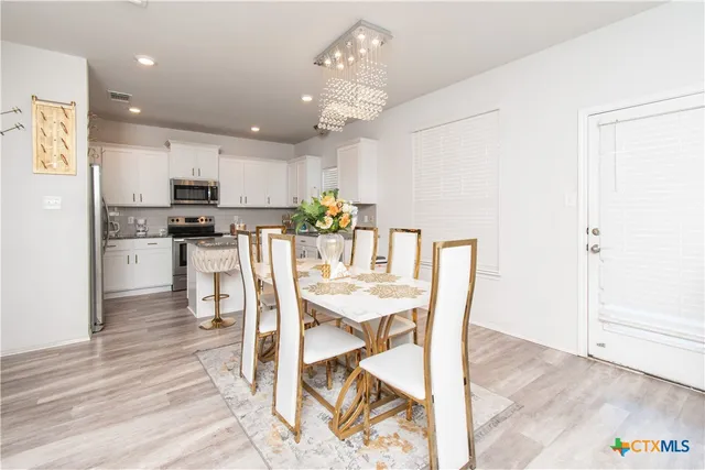 a view of a dining room with furniture and wooden floor