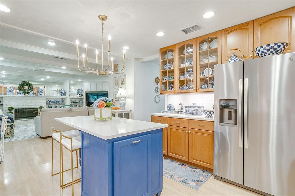 200 Lakeridge Road Lakeside, TX 76108 - Photo 16 of 32 Kitchen island with a white countertop and blue cabinetry, wood-finish flooring, recessed lighting, and a gold-toned chandelier