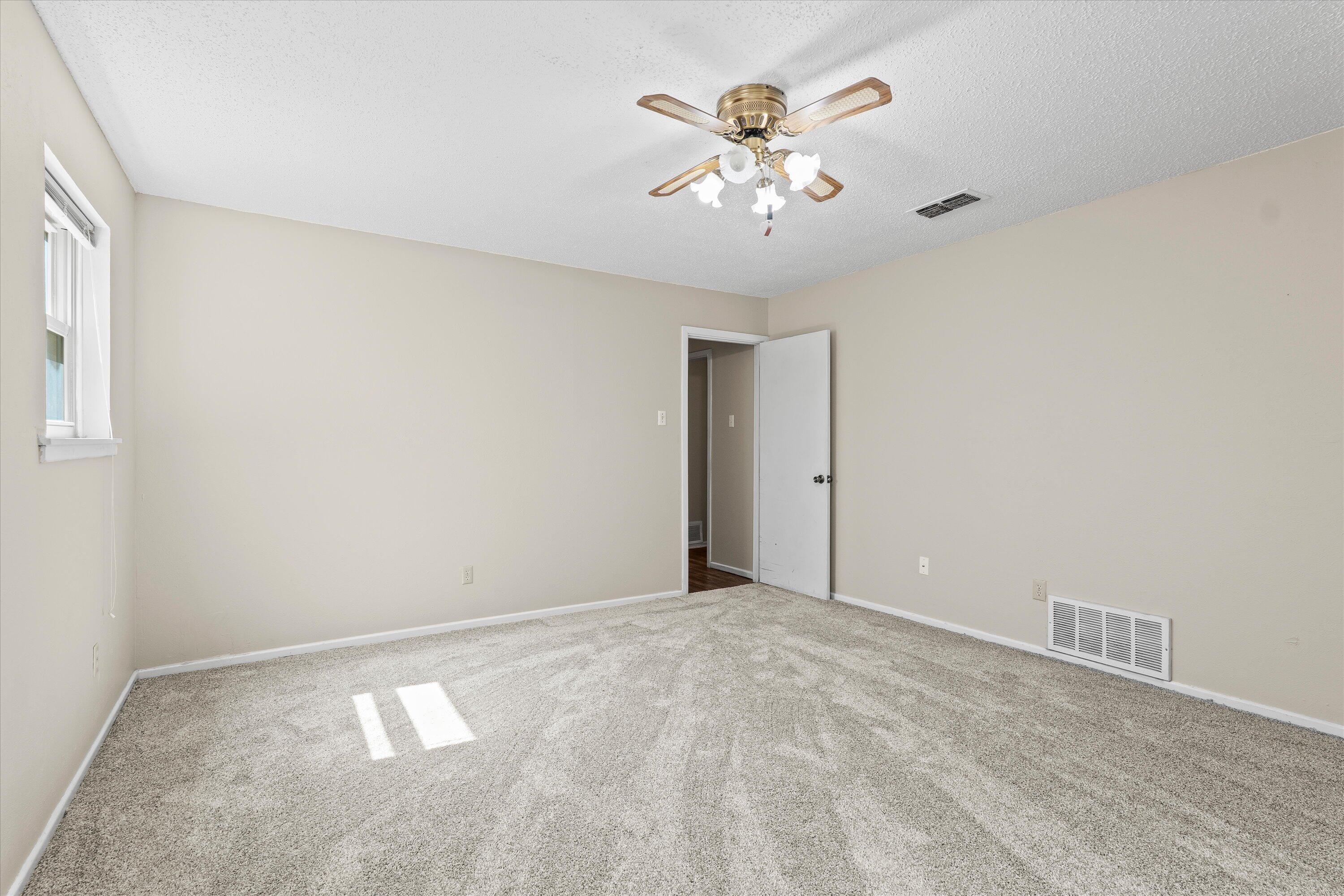 4520 54th Street Lubbock, TX 79414 - Photo 15 of 32 a view of an empty room with a chandelier fan