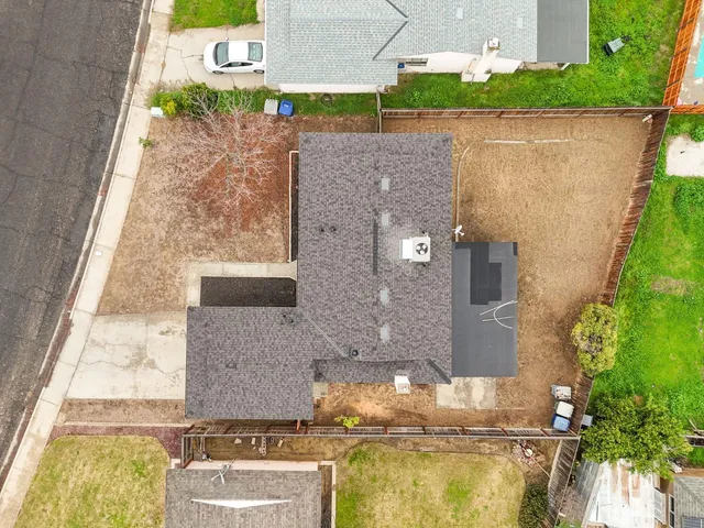 an aerial view of a house with a yard and lake view