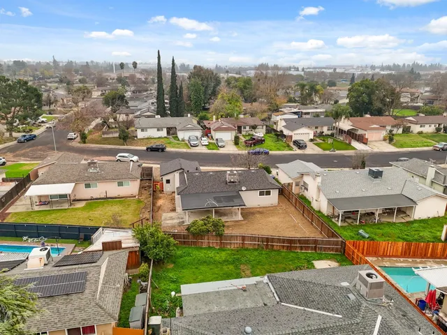 an aerial view of residential houses with outdoor space