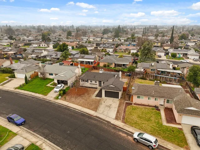an aerial view of residential houses with yard