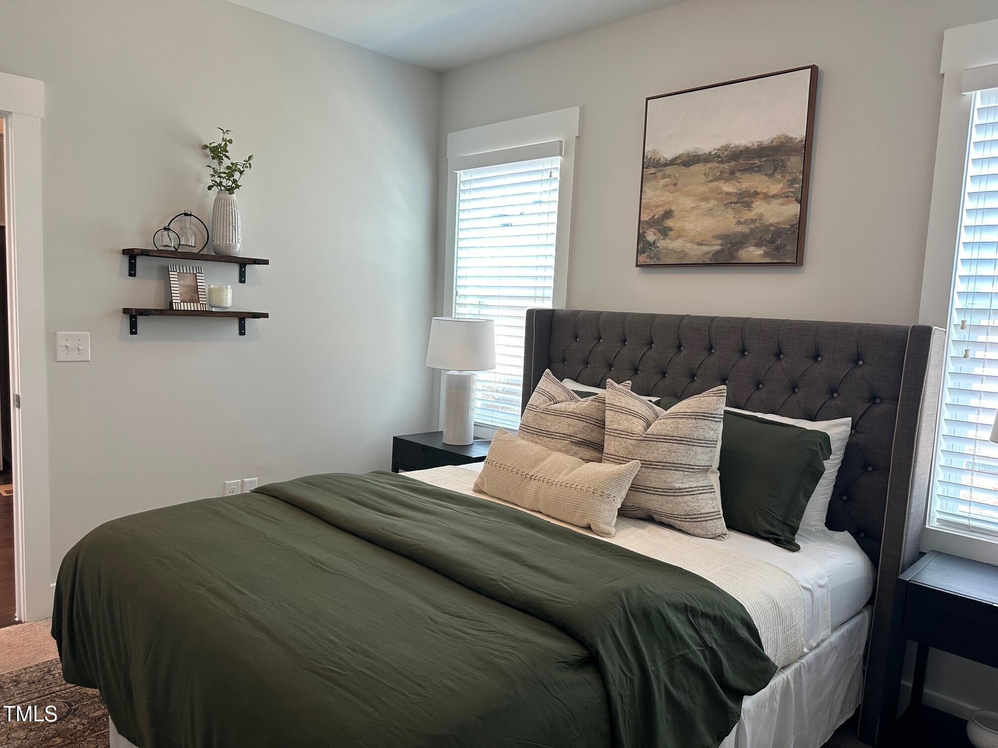 54 Cottage Way Pittsboro, NC 27312 - Photo 15 of 22 a bedroom with a bed and painting on the wall