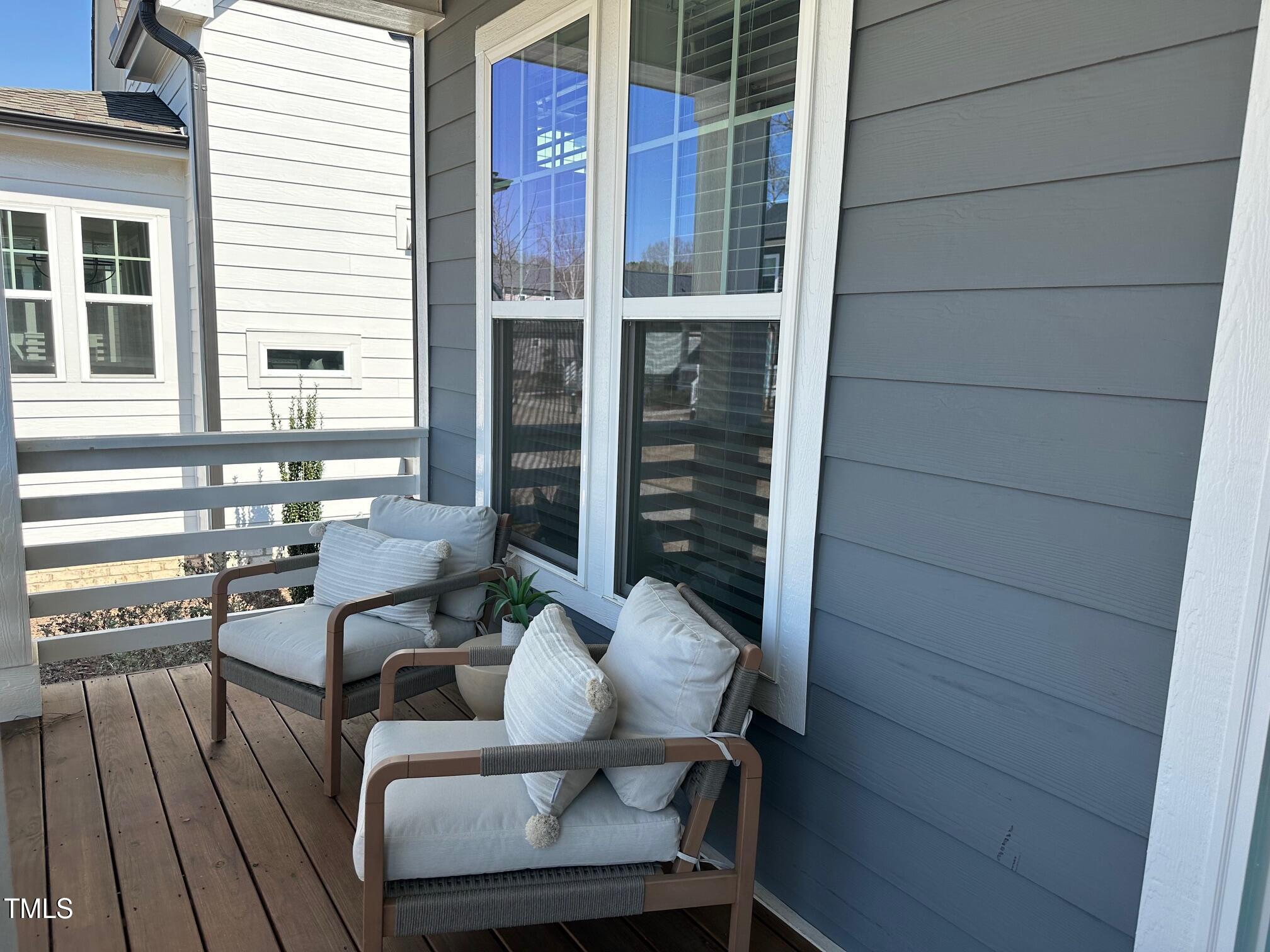 54 Cottage Way Pittsboro, NC 27312 - Photo 3 of 22 a view of balcony with chairs and wooden fence