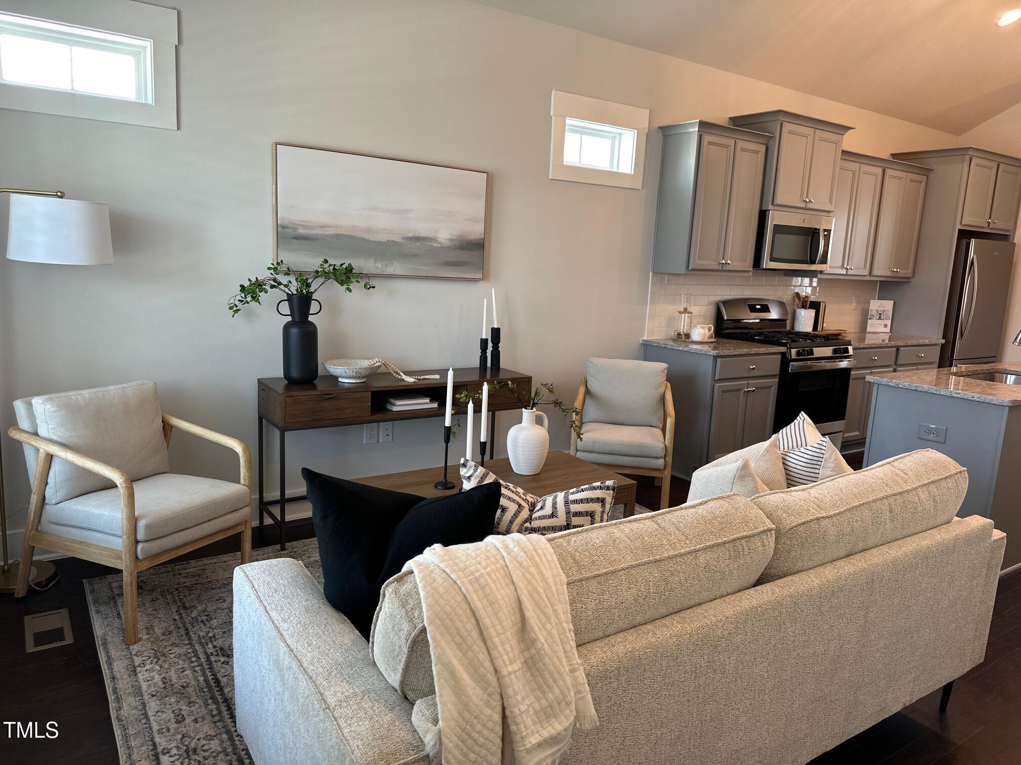 54 Cottage Way Pittsboro, NC 27312 - Photo 5 of 22 a living room with furniture a flat screen tv and kitchen view