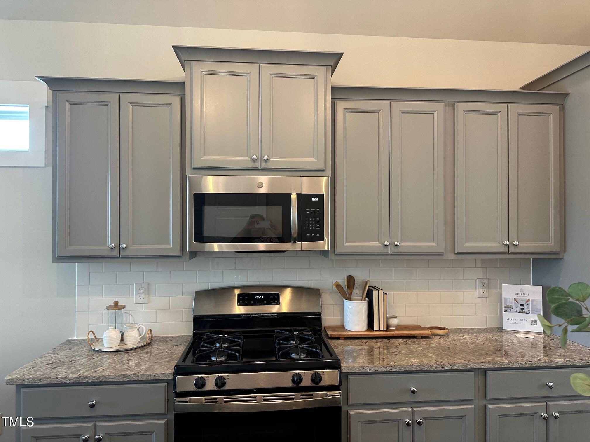 54 Cottage Way Pittsboro, NC 27312 - Photo 9 of 22 a kitchen with granite countertop white cabinets and stainless steel appliances