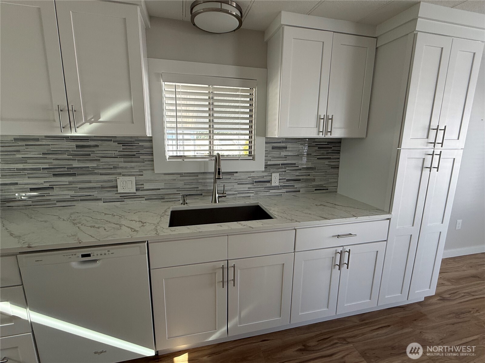 1415 84th Street Southeast, Unit 83 Everett, WA 98208 - Photo 15 of 34 a kitchen with stainless steel appliances granite countertop white cabinets and window