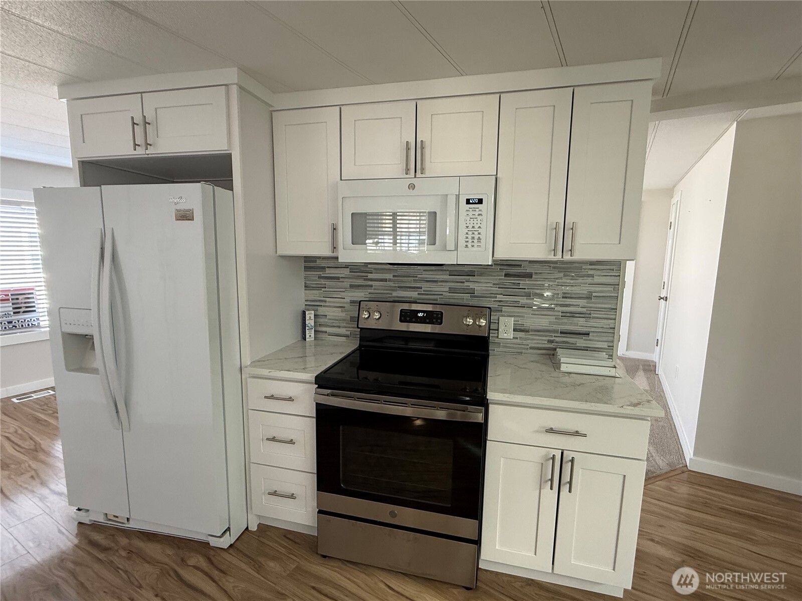 1415 84th Street Southeast, Unit 83 Everett, WA 98208 - Photo 16 of 34 a kitchen with white cabinets and stainless steel appliances