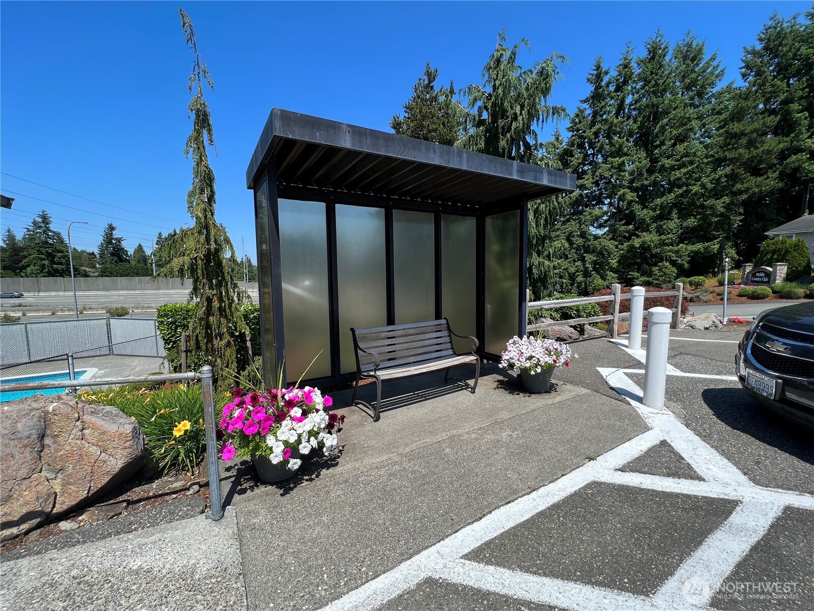 1415 84th Street Southeast, Unit 83 Everett, WA 98208 - Photo 34 of 34 a view of a patio with table and chairs potted plants with wooden fence