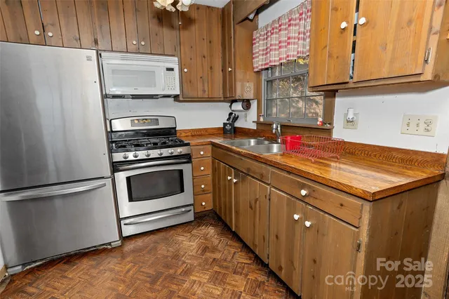 a dining room with furniture a rug and a floor to ceiling window
