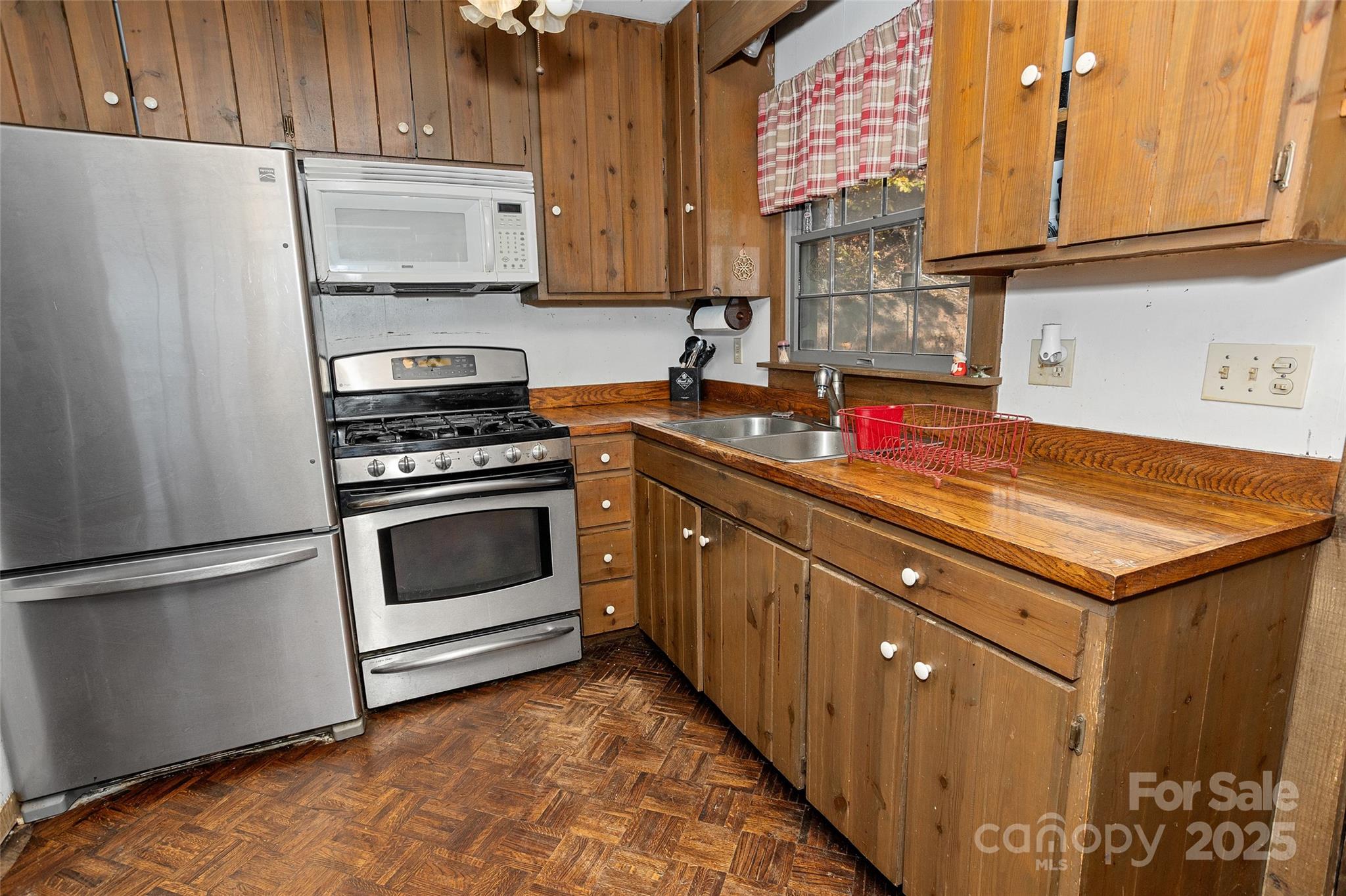 310 Log Gap Road Fairview, NC 28730 - Photo 22 of 46 a kitchen with stainless steel appliances a stove a sink and a refrigerator