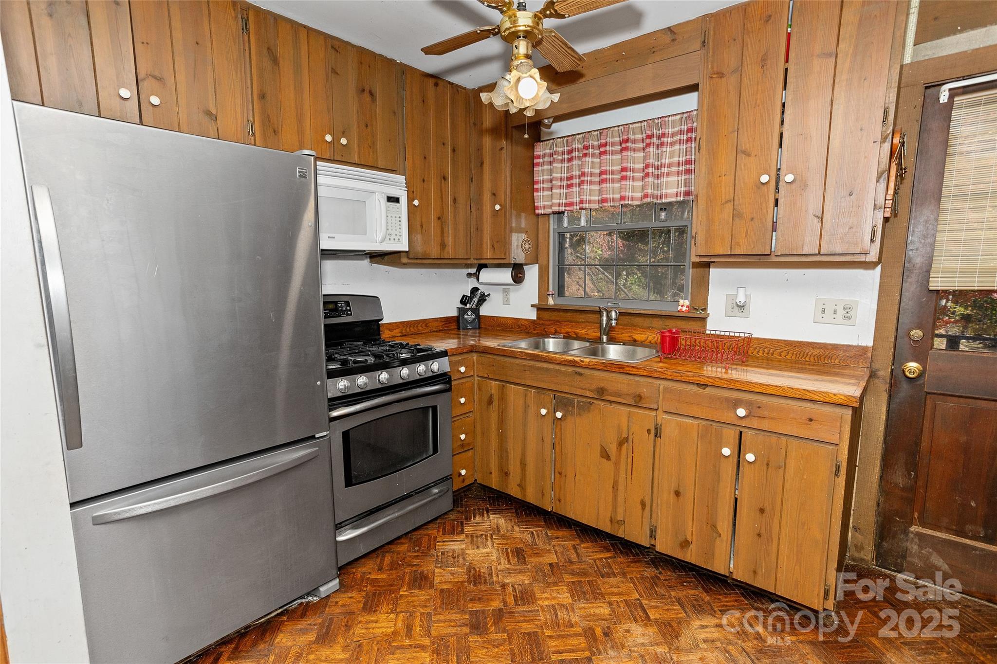 310 Log Gap Road Fairview, NC 28730 - Photo 23 of 46 a kitchen with stainless steel appliances granite countertop a refrigerator sink and stove
