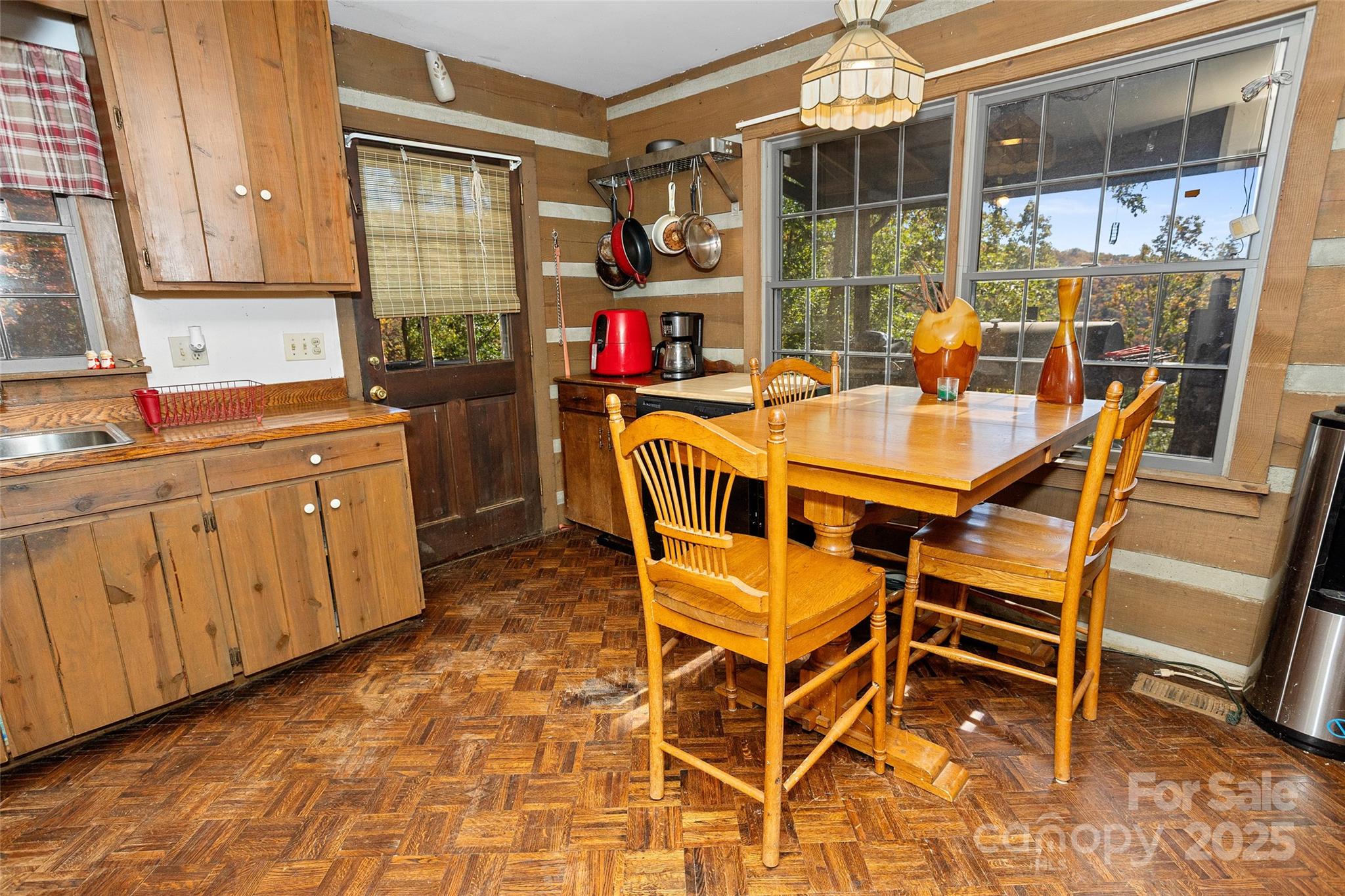 310 Log Gap Road Fairview, NC 28730 - Photo 24 of 46 a dining room with furniture a rug and a floor to ceiling window
