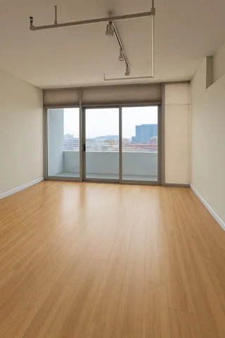 a bedroom with a bed dresser and a large window