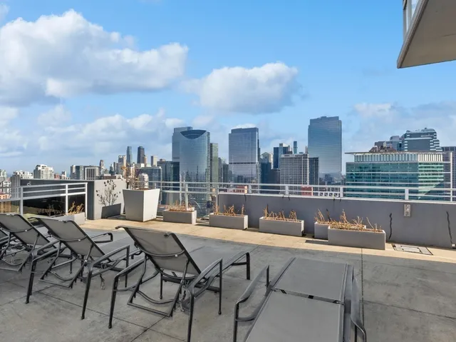 a view of balcony with a barbecue grill and outdoor seating