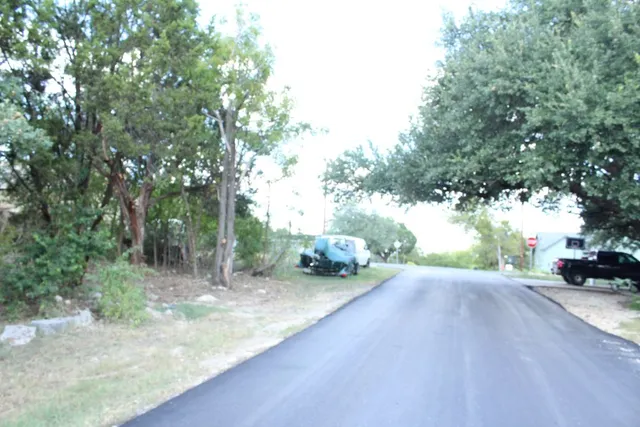 a view of a road with trees in front of it