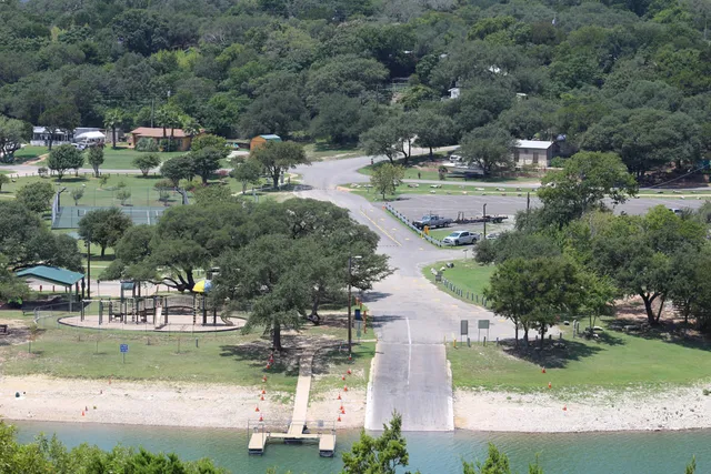 an aerial view of residential houses with outdoor space and parking