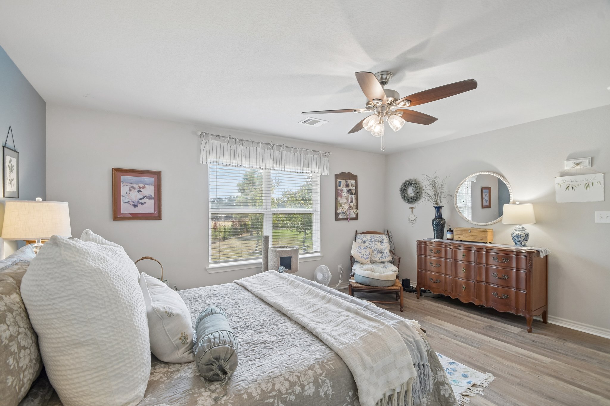 596 Pleasant Grove Loop Elgin, TX 78621 - Photo 21 of 37 Hardwood floors and natural light from a large window define this bedroom.