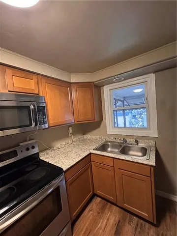 a kitchen with stainless steel appliances granite countertop a sink stove and microwave