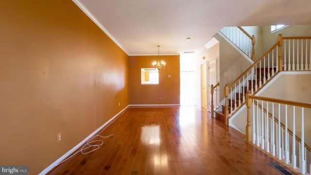 a view of entryway with wooden floor and stairs