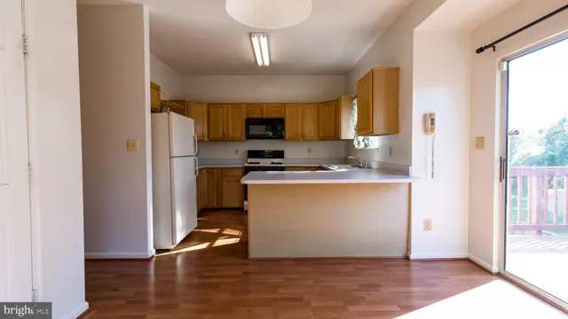 a view of an entryway with wooden floor and a window