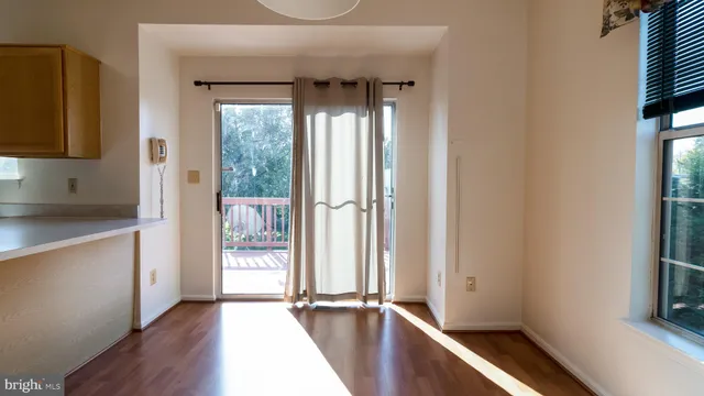 a view of hallway with wooden floor and electronic appliances