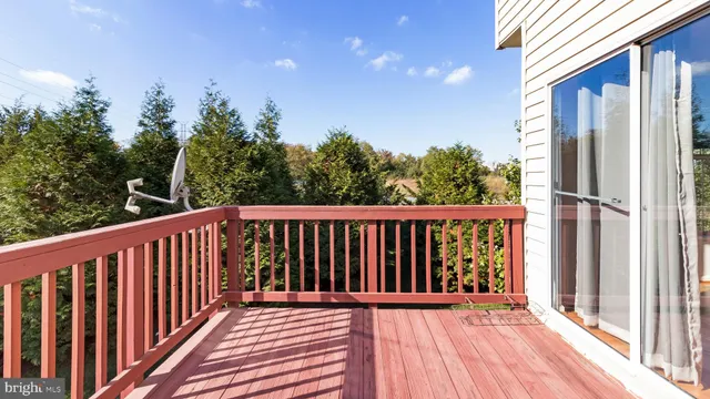 a balcony with wooden floor and fence