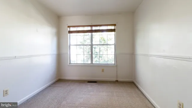 an empty room with closet and a bathroom