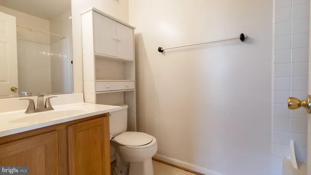 a bathroom with a sink and mirror with toilet