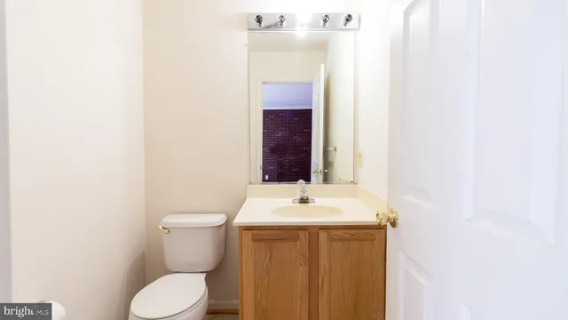 a bathroom with a sink a toilet and mirror