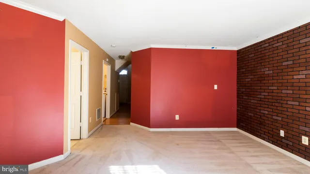 a view of an empty room with a fireplace and a window