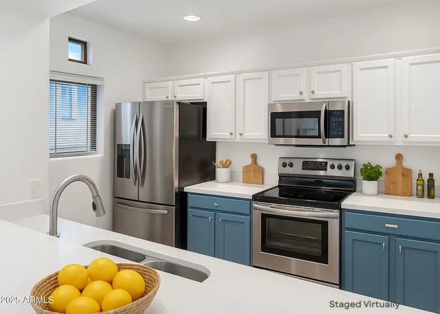 a kitchen with stainless steel appliances granite countertop a stove top oven a refrigerator and a sink with granite countertops