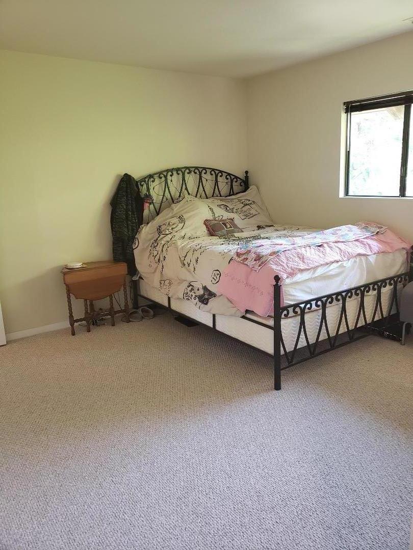 9500 Center Street, Unit 19 Carmel, CA 93923 - Photo 6 of 12 a bedroom with a bed chair and a window in it