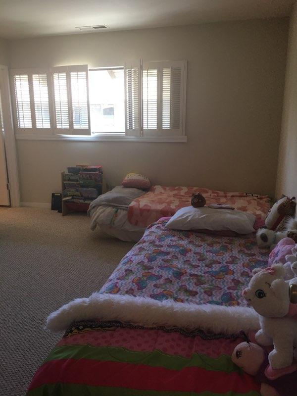 9500 Center Street, Unit 19 Carmel, CA 93923 - Photo 7 of 12 a bed sitting in a bedroom next to a window