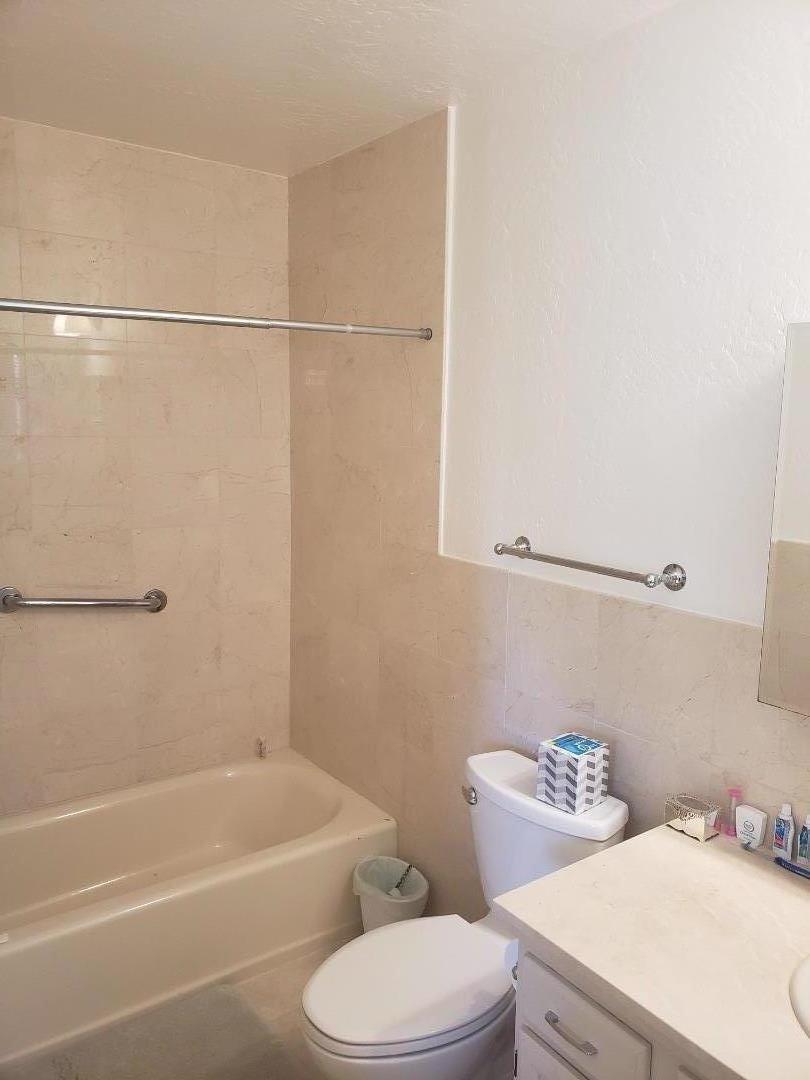 9500 Center Street, Unit 19 Carmel, CA 93923 - Photo 8 of 12 a white toilet sitting next to a bath tub