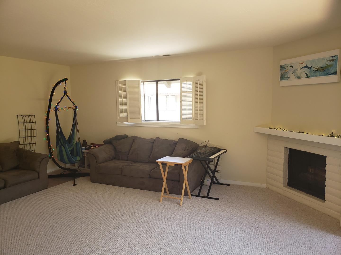 9500 Center Street, Unit 19 Carmel, CA 93923 - Photo 9 of 12 a living room with furniture a flat screen tv and a window