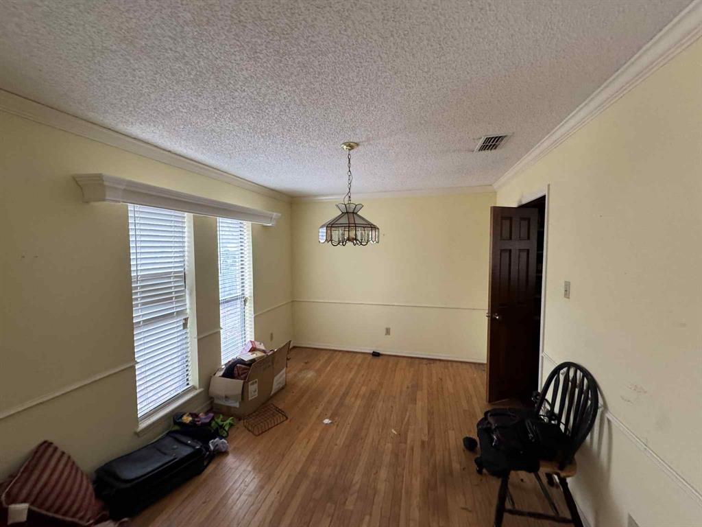1316 Edna Street Commerce, TX 75428 - Photo 2 of 16 a room with a window and wooden floor